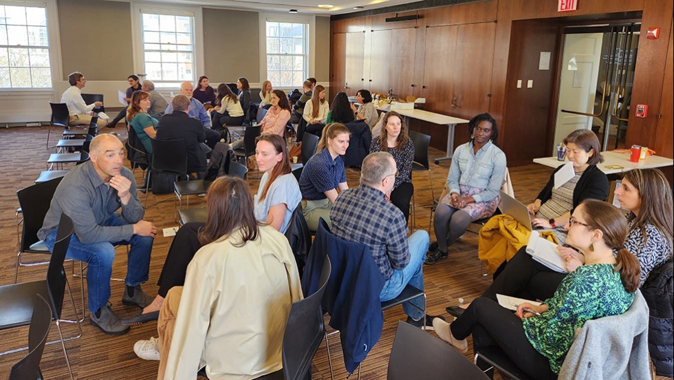 people talking in groups in a room