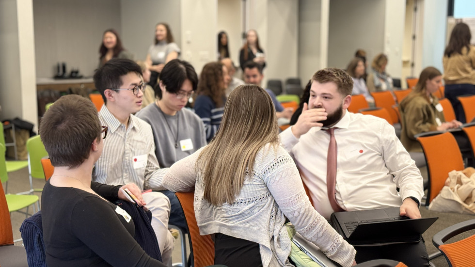 Group of students sitting in chairs talking.
