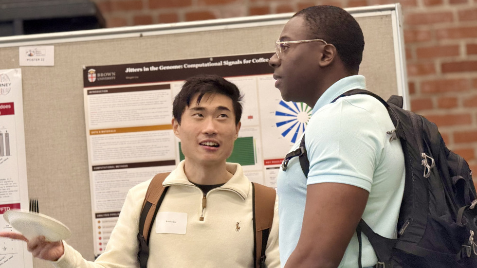Poster presenter talking to a student.